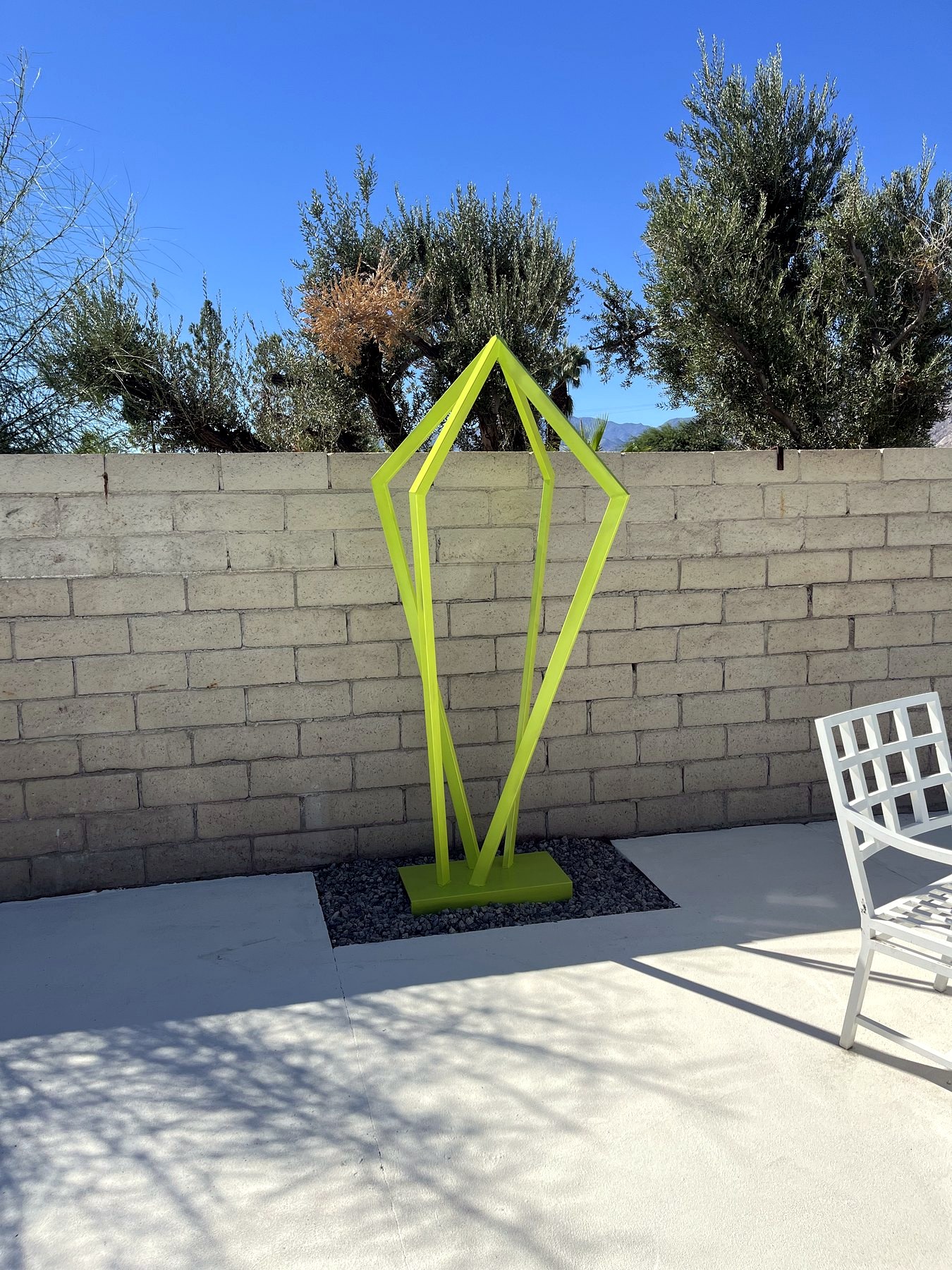 Bright green Mid Century Metal sculpture outdoors